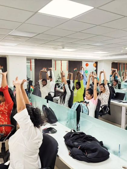 More from a corporate wellness session, with everyone joining in for some gentle stretches. These programs are designed to be accessible to everyone, regardless of fitness level.