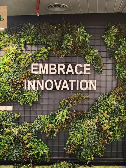 For this corporate office, we designed and installed a custom artificial green wall that frames their company motto. This zero-maintenance installation adds a powerful visual impact and a dose of nature to the modern workspace, making it a memorable feature for employees and visitors.
