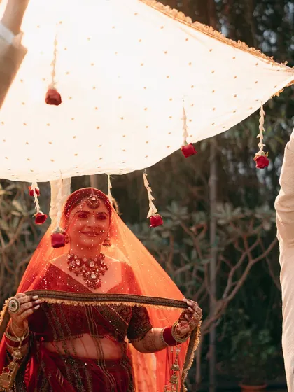 A simple, beautiful Varmala under a phoolon ki chadar of red roses. This moment at Oleander Farms was all about the couple, surrounded by nature and love.