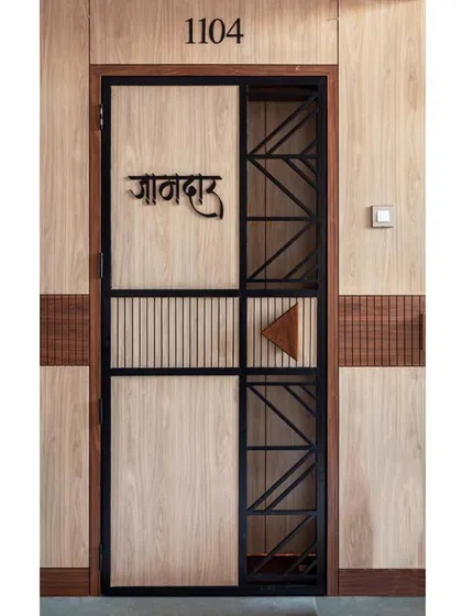 We transformed this entryway by fabricating a new, modern safety door that incorporates the existing metal grid, blending security with style.