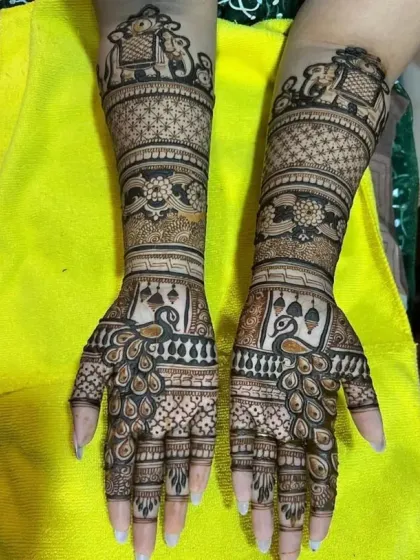 This full-arm bridal design showcases our expertise in traditional motifs. Notice the symmetrical patterns, the detailed elephants on the forearm, and the graceful peacocks on the palms.