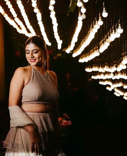 Another angle of this stunning cocktail look. The warm lighting highlights the dewy finish on her skin and the soft glam makeup, creating a look that is both sophisticated and party-ready.