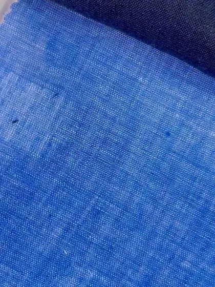 A bright blue linen-blend fabric, offering a more casual and textured look for summer blazers or shirts.