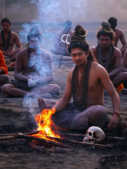 My spiritual practice is rooted in deep traditions, like those of the sadhus who sit by the fire. This image represents the transformative power of turning away from worldly noise to listen to the inner self, a core principle I bring to my guidance sessions.