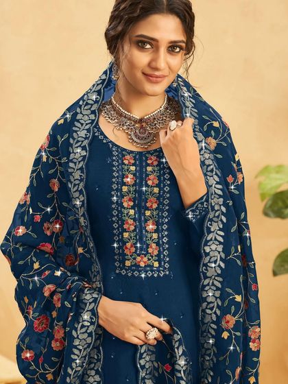 A classic blue salwar kameez with a beautifully embroidered floral dupatta. It's a versatile piece that can be dressed up or down for any event.
