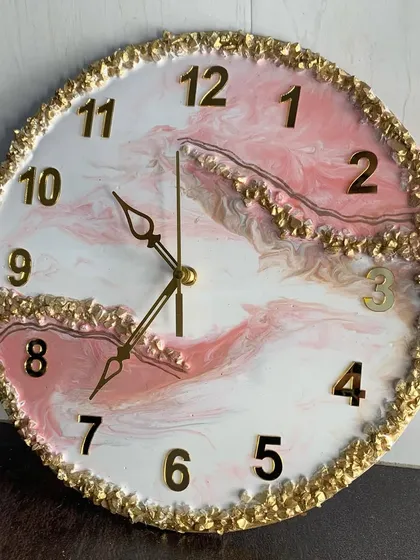 A beautiful pink and white marble clock with a full border of gold crystals and modern numerals.
