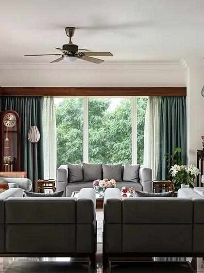 This living room is filled with the client's treasured antique furniture and art from their travels. We created a design that honors these pieces, blending traditional Indian elements with comfortable, contemporary living.