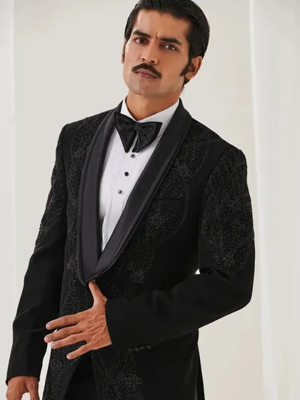 A portrait in the Nazaakat velvet tuxedo, highlighting the shawl lapel and the intricate texture of the fabric.
