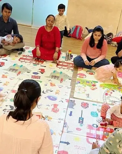 Our sessions are a mix of guided activities and free exploration. Here, parents and children are enjoying some unstructured play with instruments, which encourages creativity.