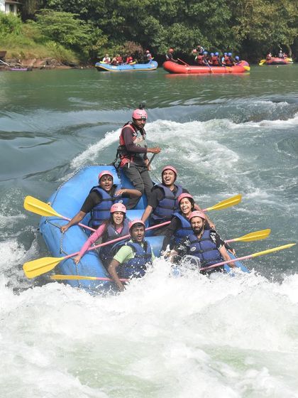 A team enjoying the thrill of the rapids during a rafting session in Dandeli. The excitement on their faces says it all!
