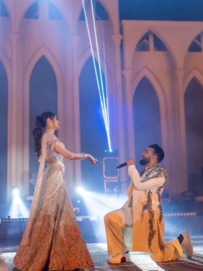 A serenade on stage. I work with artists and the couple to choreograph special moments like this, using dramatic laser lights and stage effects to amplify the romance and create a memorable performance.