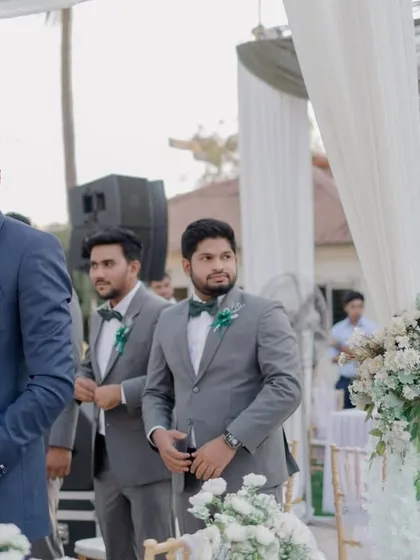 The groom's emotional reaction as he sees his bride walking down the aisle for the first time at their Christian wedding.