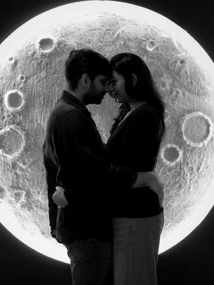 A romantic couple's silhouette against our moon backdrop. This black and white image is perfect for capturing the deep connection and shared dream of the parents-to-be.