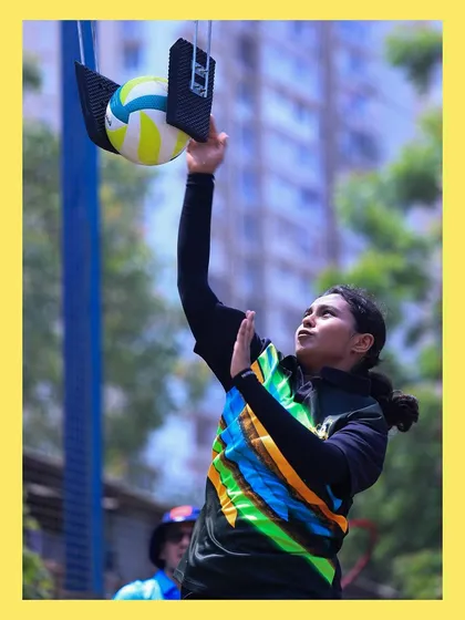 A female player practices her spike on the training rig, building the power and technique needed to dominate at the net.