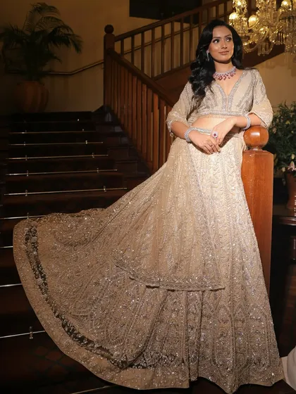 The full lehenga in all its glory. The soft, monochrome makeup perfectly balances the heavily embellished outfit, creating a look of pure elegance.