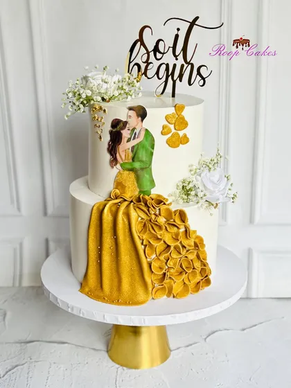 Back by popular demand, this engagement cake design features a romantic edible portrait with a flowing golden gown. It's a testament to a love story that never goes out of style.
