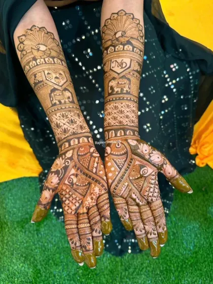 This design combines peacocks on the palms with elephants and personalized initials on the arms, a perfect mix of popular traditional motifs.