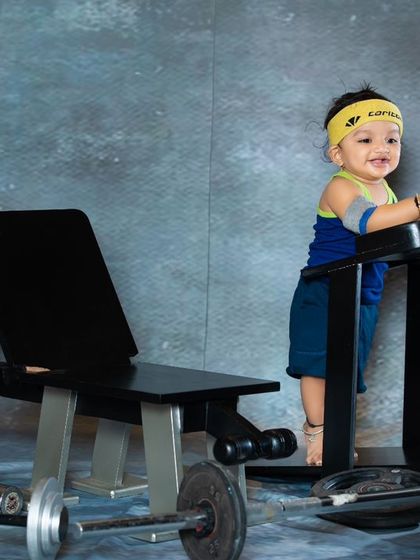 Working up a sweat on the mini treadmill. This baby's happy expression shows that fitness can be fun at any age.