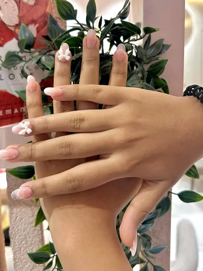 The perfect combination of a subtle ombré and cute 3D bows. This is a great example of our custom nail extension work.