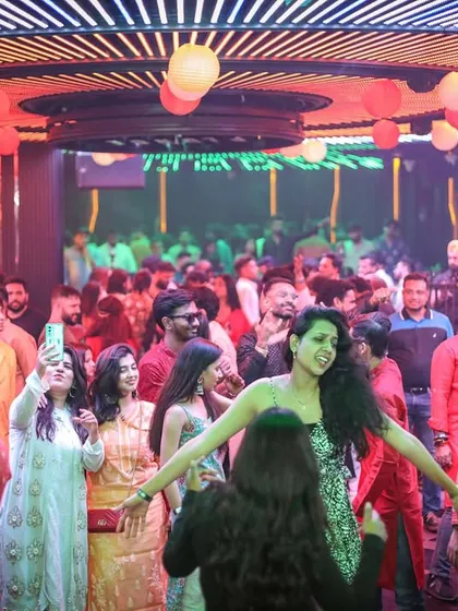 A wide shot of a packed dance floor at a desi night. This is the goal for every event: a room full of people smiling, dancing, and making memories.