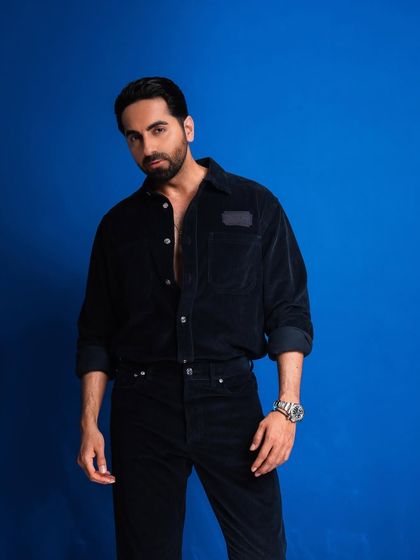 A medium shot from the same series, focusing on his confident stance and direct gaze.