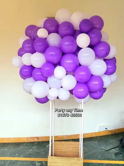 A hot air balloon prop made of purple and white balloons. This is a unique and fun prop for a baby's photo shoot.