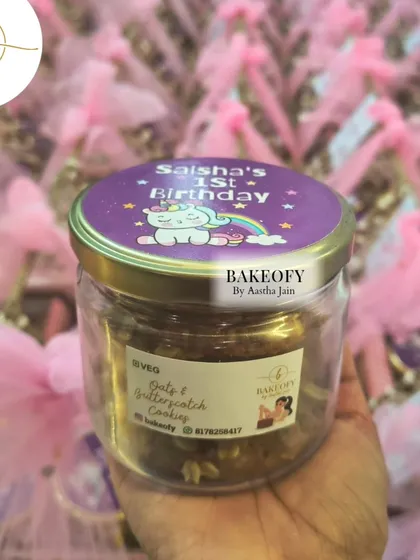One of the items in the hamper: a jar of our freshly baked Oats & Butterscotch cookies, complete with a custom "Saisha's 1st Birthday" unicorn-themed lid sticker.