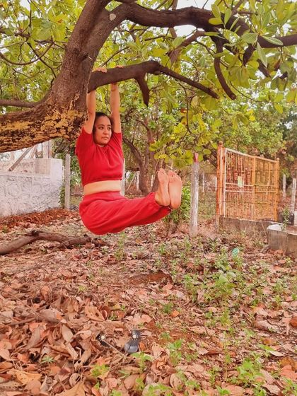 Yoga everywhere. An L-sit hold, or Brahmacharyasana, hanging from a tree branch. Nature provides the best playground for practice.