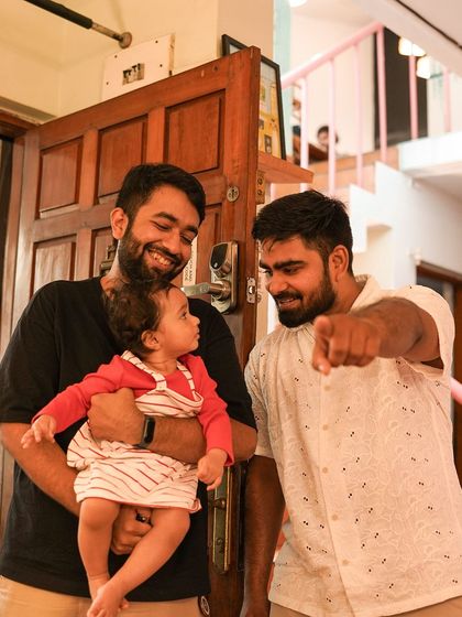 Two friends and a baby share a laugh, enjoying the community atmosphere of our event.