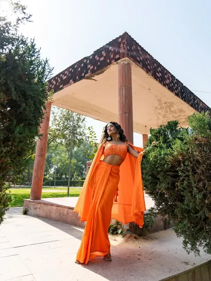 New pieces in now, like this vibrant orange dhoti saree. Call or WhatsApp us to rent or buy this stylish Indo-western outfit.