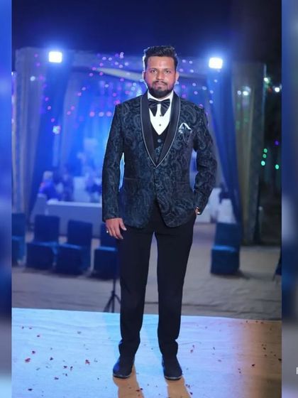 A full-length view of the client in his tuxedo, looking ready to own the stage at his event.