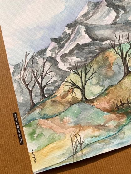 This winter landscape in watercolor shows bare trees on a gentle slope with snow-capped mountains in the distance. It captures the quiet patience of nature, a feeling I try to bring into my painting process.