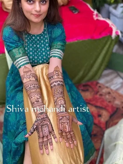 This client is all smiles with her wedding story mehendi, which narrates her special day through intricate illustrations on her arms.