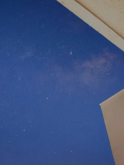 A glimpse of the Milky Way galaxy is visible in the night sky over Pune, captured from a balcony.