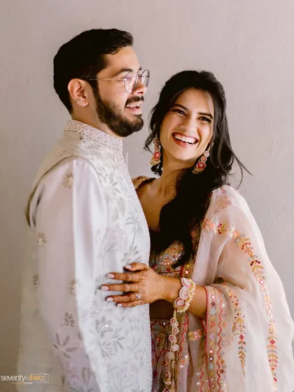 The kind of laughter that fills a room. This candid black and white portrait captures the genuine happiness and easy comfort between a couple.