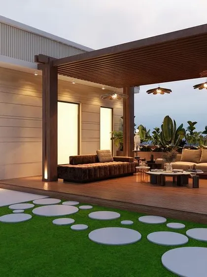 A wide view of the Golf Course Road project, showing the covered lounge area under a wooden pergola. The design uses a mix of natural materials and clean lines to create a modern yet warm outdoor living room.