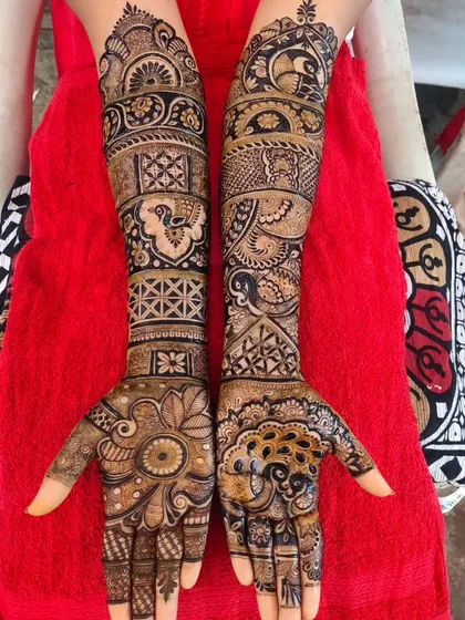 An intricate design with a mix of peacocks, paisleys, and geometric patterns. The different textures and motifs create a very dynamic and full look.
