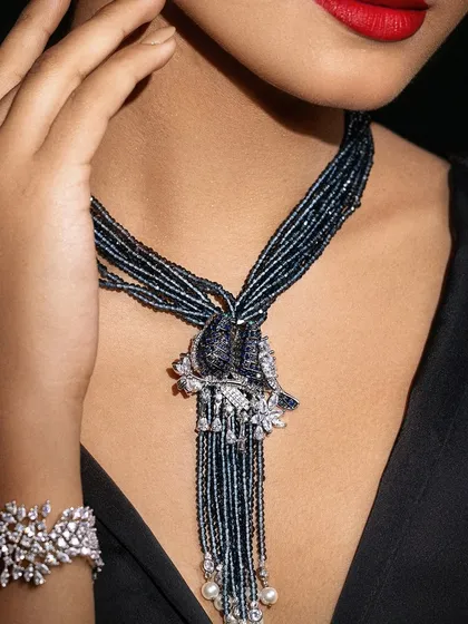 A close-up on the intricate diamond and bead work of the necklace and bracelet. This type of detail-oriented styling is crucial for jewelry campaigns.