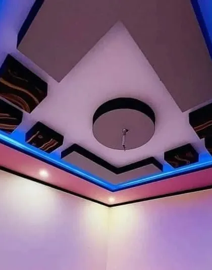 A compact and stylish design for a smaller room. The use of blue and pink cove lighting in a simple geometric layout adds a touch of personality and fun.