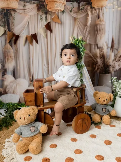 A handsome portrait of the little brother with his teddy bears during the sibling session.
