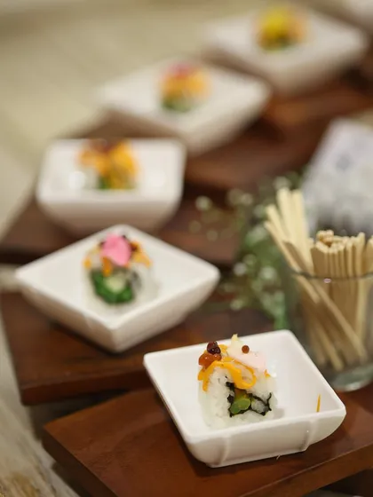 A closer view of our sushi appetizers, showcasing the different varieties and colourful garnishes. Each roll is a carefully constructed bite of flavour and texture.
