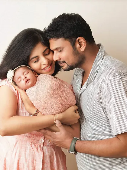 A new family of three, wrapped in a loving embrace. This photo captures the warmth and security of their new family unit.