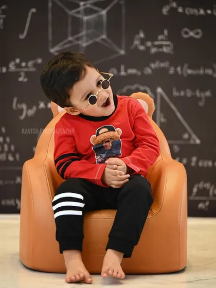 Capturing a playful and expressive moment during the 'little professor' themed studio shoot.