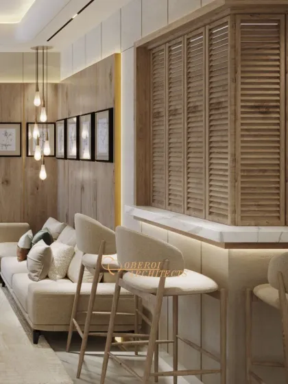 This view shows the integrated bar seating, which creates a casual social hub within the main living area. The louvered wood panel adds texture and visual interest.
