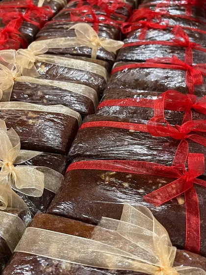 My rich, dense Christmas fruit cakes, all wrapped up and ready to go. These are packed with soaked fruits and nuts, making them a traditional and heartwarming holiday gift.