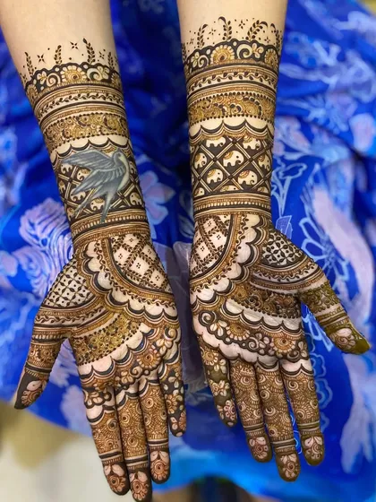 A unique bridal design featuring a custom bird motif on one arm, paired with a geometric pattern on the other.
