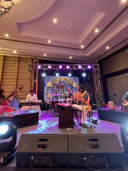 The full band on stage, creating a grand musical experience for a private event.