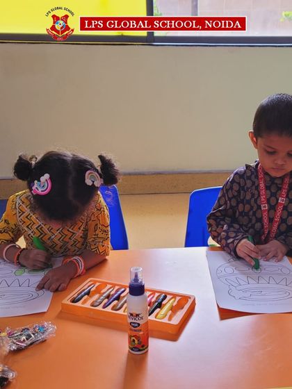 Students work on their Janmashtami-themed coloring sheets. These quiet, focused activities are a great way for our youngest learners to engage with the festival's symbols and stories.
