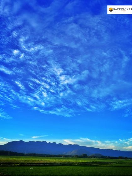 A breathtaking view of the sky and mountains on the way to Munnar.