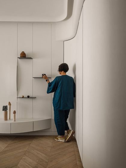 A personal moment of arranging details in the master bedroom, showing the care and thought that goes into every corner.